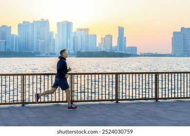 Man senior, mature jogging on promenade at sunrise. - Powered by Shutterstock