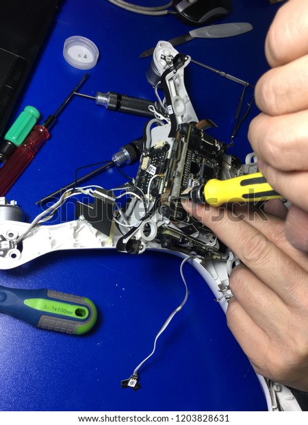Man in the service center for maintenance of
drones, eliminates the
fault