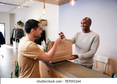 Man Serving Customer At The Counter In A Clothing Store