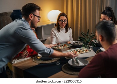 Man Serving Food At The Home Dinner Party