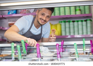 Man Serving Ice Cream In Confectionery Shop