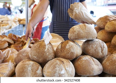 Man Serving On Bread Stall At Outdoor Market