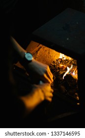 Man setting a fire in a fireplace