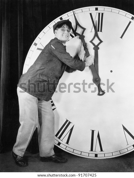 Man setting time on a big\
clock