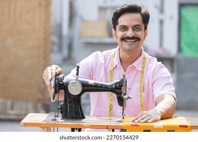 Man sewing clothes with sewing machine