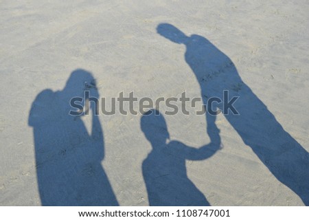 Similar – zwei erwachsene und ein kind in badebekleidung auf einem roller am meer. verschwommen