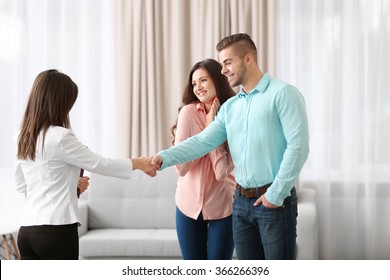 Man Shaking Hands With Estate Agent In New Home