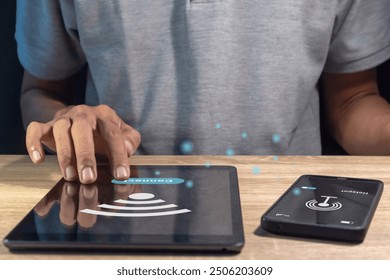 Man sharing internet between mobile phone and tablet pc by using personal hotspot