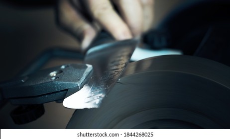 Man sharpens knives on a grinder. Macro shoot - Powered by Shutterstock