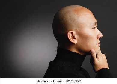 Man With Shaved Head, Hand On Chin, Profile