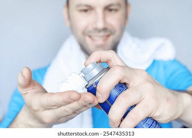 A man shaves in front of a mirror. Shaving foam. Disposable razor. - Powered by Shutterstock