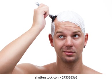 A Man Shaves His Head Thoughtfully