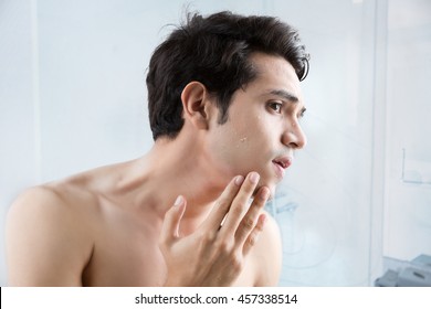 Man Shaving In The Bathroom.