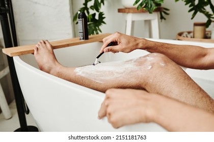 Man shaving his leg in bathroom - Powered by Shutterstock