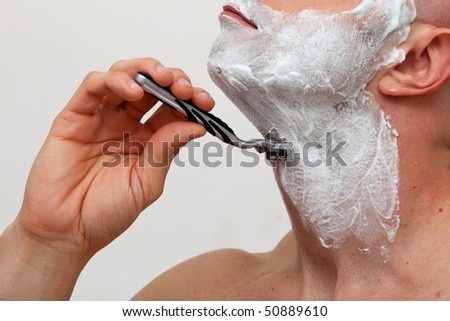 Man shaving with a razorblade