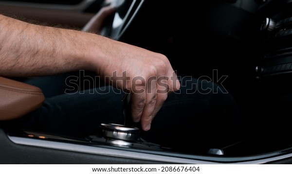 Man shifts gears\
with joystick with one hand