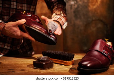 Man Shining Shoes With A Rag.