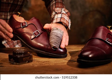 Man Shining Shoes With A Rag.