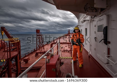 A man in ship's fire outfit on board a vessel 