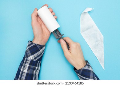 Man In A Shirt Changes The Hair Removal Roller. Lint Rollers For Pet Hair, Sticky, Remover For Couch, Clothes Furniture And Carpet. Blue Background. Flat Lay. Top View.