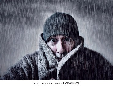 Man Shivering In Torrential Rain.