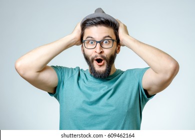 Man with shocked, amazed expression isolated on gray background