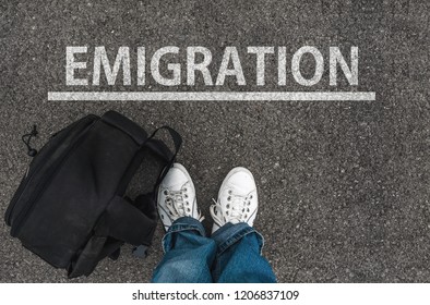 man with a shoes and backpack is standing next to line and word EMIGRATION - Shutterstock ID 1206837109