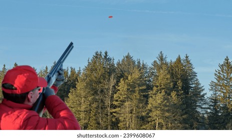 man shooting at clay pigeon