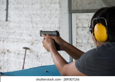 the man shooting with gun 