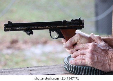 Man Shooting Pellet Gun Outdoors