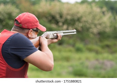Man Shooting Skeet With A Shotgun. Skeet Shooting, Trap Shooting.