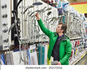 Man Shopping For Bathroom Equipment In DIY Shop