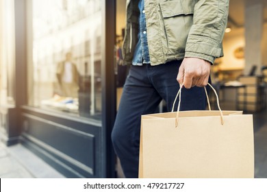 Man Shopping In Clothing Store Carry A Paper Bag