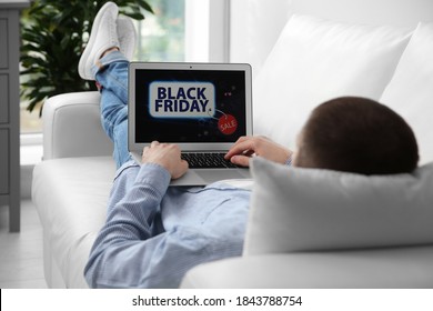 Man shopping online using laptop on couch at home, closeup. Black Friday Sale - Shutterstock ID 1843788754
