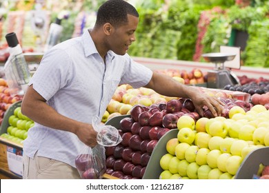 Man Shopping In Produce Section Of Supermarket