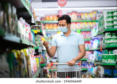 Man Shopping In A Supermarket Wearing A Medical Face Mask