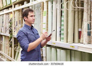 Man shopping wallpapers in DIY shop for construction