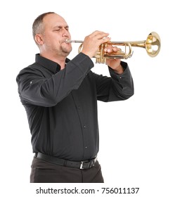 A man with a short haircut in a black shirt plays trumpet on a white isolated background