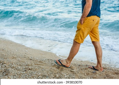 Man In Shorts Walking On The Beach