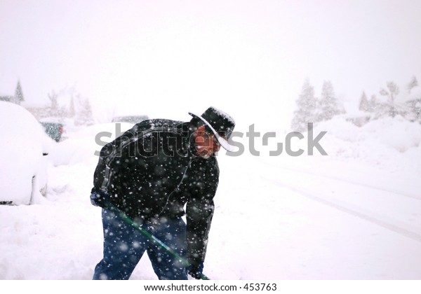 Man Shoveling Snow in Snow\
Storm