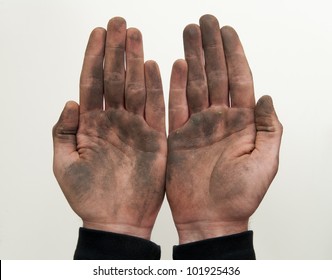 Man show his dirty hands with palms up isolated on white.