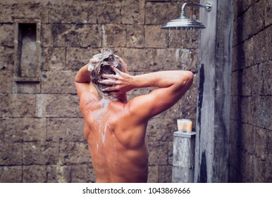 Man showering and washing head