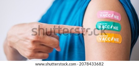 Man showing bandage after receiving covid 19 vaccine. Vaccination, herd immunity, side effect, booster dose, vaccine passport and Coronavirus pandemic