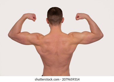 Man Showing Biceps Hands Up. Sportsman Showing Muscles. ABS, Biceps Muscles. Back View - Shutterstock ID 2079659314