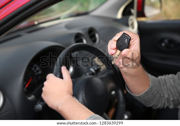 Man showing
car key from new automobile,
closeup