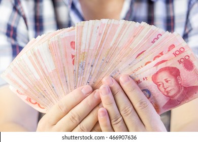 Man Showing Chinese Money Holing In Hands