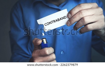 Man showing Contraband word on paper.