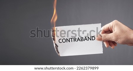 Man showing Contraband word on paper.