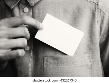 Man showing empty business card. Adult businessman takes out blank Card from the pocket of his shirt. Ready for your private information. Black and White. Horizontal mockup