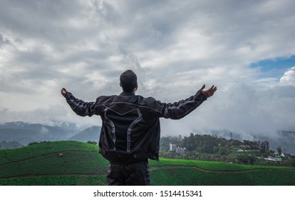 Man Showing His Beautiful Expression Above Tea Garden Image Is Taken At Munnar Kerala India From Low Angle Showing The Completion Of Journey Of Bike Trip And The Beautiful Nature.